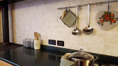 a kitchen counter with a pot on a stove at Casa Rossi in Le Grazie