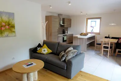 a living room with a couch and a table at Privatpension Bergkristall in San Martino