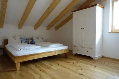 a bedroom with a bed and a cabinet in it at Privatpension Bergkristall in San Martino