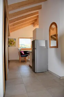 a kitchen with a refrigerator and a table at Privatpension Bergkristall in San Martino