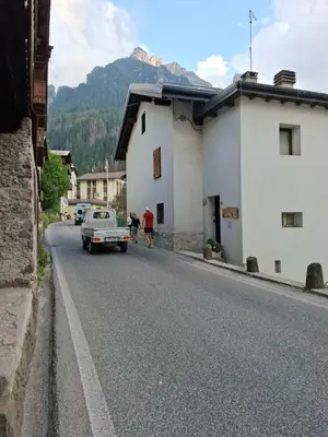 a street in a village with a mountain at Una Civetta sul Lago in Alleghe