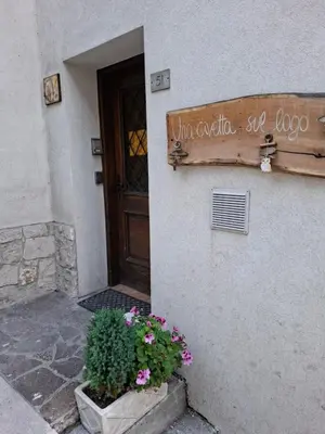 a sign on the side of a building with flowers at Una Civetta sul Lago in Alleghe