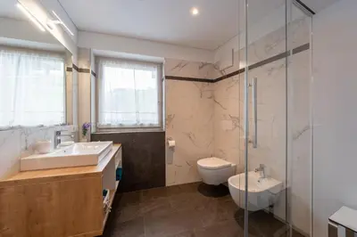 a bathroom with a sink and a toilet and a shower at Ciasa Pradac in San Vigilio Di Marebbe