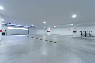 an empty parking garage with two bikes parked in it at Ciasa Pradac in San Vigilio Di Marebbe