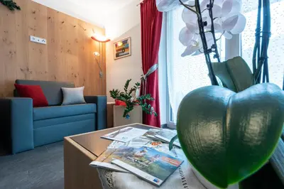 a living room with a heart shaped vase on a table at Ciasa Pradac in San Vigilio Di Marebbe