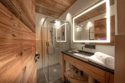 a bathroom with a shower and a sink and a mirror at Rifugio Salei in Canazei