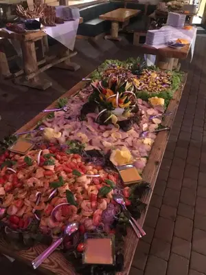 a table filled with many different types of food at Rifugio Salei in Canazei