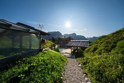 a pathway leading up a hill to a house at Rifugio Salei in Canazei