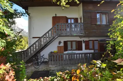 a house with a staircase and a bike parked outside at Lungoboite 14 - Cortina in Cortina dʼAmpezzo