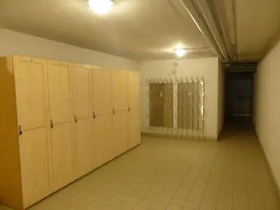 an empty room with lockers and a gate at Appartamenti Le Plejadi in Cavalese