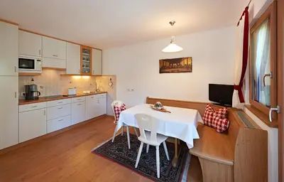 a kitchen with a table and chairs in a room at Apartment Albert in Santa Cristina in Val Gardena