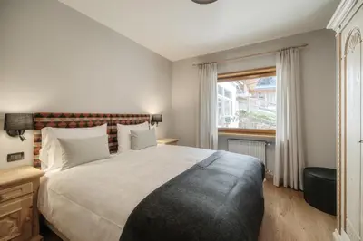 a bedroom with a large bed and a window at Residence Telemark in Santa Cristina in Val Gardena