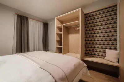 a bedroom with a bed and a wall of wine bottles at Residence Telemark in Santa Cristina in Val Gardena