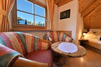 a room with a couch and a table and a bed at Albert - Bon Di in Santa Cristina in Val Gardena