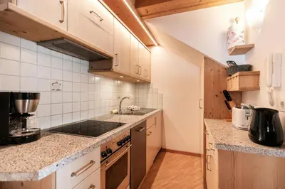 a kitchen with a sink and a stove top oven at Albert - Bon Di in Santa Cristina in Val Gardena