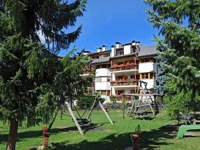 a hotel with a playground in front of a building at Albert - Bon Di in Santa Cristina in Val Gardena