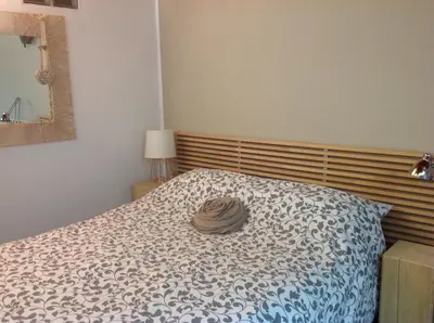 a bedroom with a bed with a hat on it at Home White in Laives