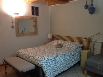 a bedroom with a bed and a mirror and a chair at Home White in Laives