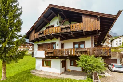 a house with wooden balconies on top of it at Villa Ca Perosego - Stayincortina in Cortina dʼAmpezzo