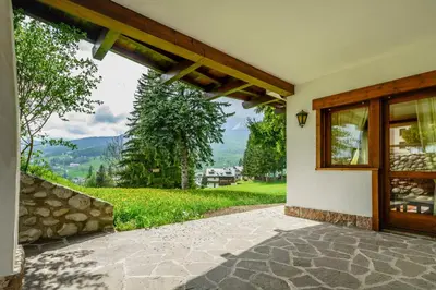 a door to a house with a view of a mountain at Villa Ca Perosego - Stayincortina in Cortina dʼAmpezzo