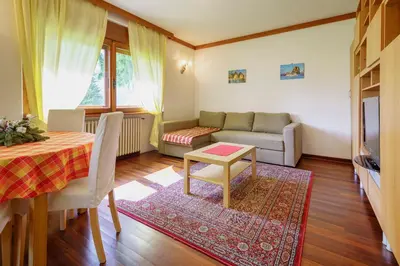 a living room with a couch and a table at Villa Ca Perosego - Stayincortina in Cortina dʼAmpezzo