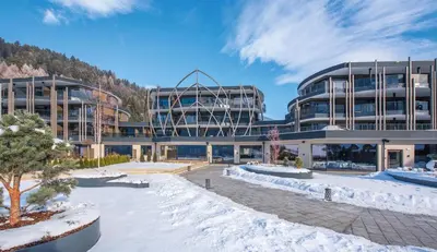 a large building with snow on the ground at Leitgam Adults Only Hotel in Chienes