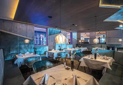a dining room with tables and chairs and lights at Leitgam Adults Only Hotel in Chienes