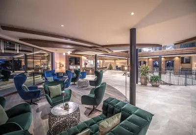 a lobby with couches and chairs in a building at Leitgam Adults Only Hotel in Chienes