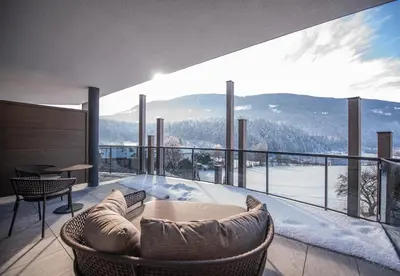 a room with a balcony with a view of the mountains at Leitgam Adults Only Hotel in Chienes