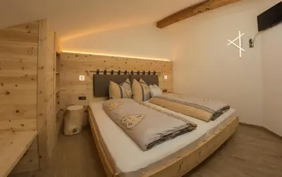 a bathroom with a sink and a mirror at Apartments Edera in Selva di Val Gardena