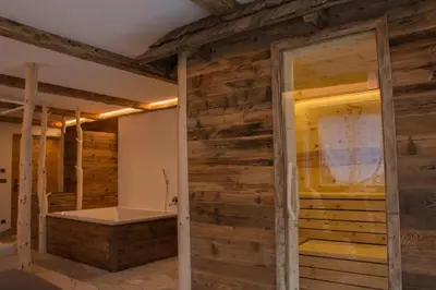 a bedroom with a bed with two towels on it at Apartments Edera in Selva di Val Gardena