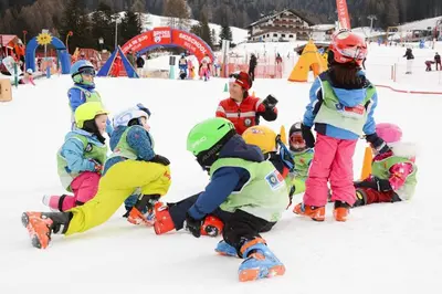 a group of children playing in the snow at Garni Waltoy in Selva di Val Gardena