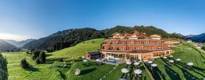 an aerial view of a large building on a hill at Panorama Resort Taljörgele in Ridanna