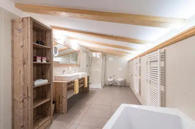 a bathroom with a white tub and a sink at Panorama Resort Taljörgele in Ridanna