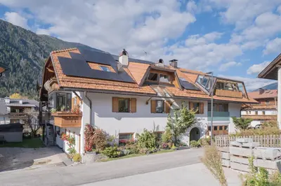 a house with solar panels on the roof at Bio.top.Appartement in Rasun di Sopra