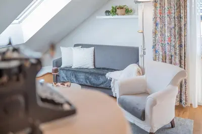 a living room with a couch and a chair at Bio.top.Appartement in Rasun di Sopra