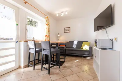 a living room with a table and a couch at Appartements Haus Pichler in Eggen