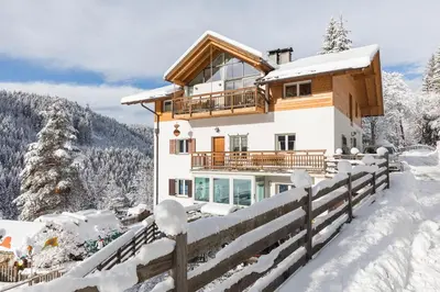 a house in the snow with a fence at Appartements Haus Pichler in Eggen
