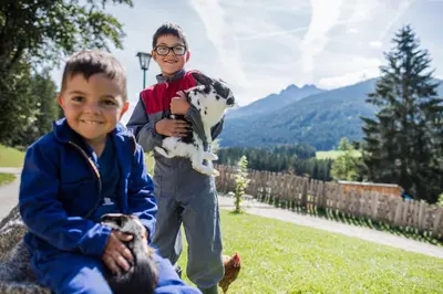 two young boys are holding a stuffed cow at Haubenthal in Villabassa