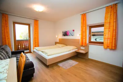 a small bedroom with a bed and a bathroom at Schötzerhof in Meltina
