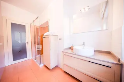 a white bathroom with a sink and a mirror at Josefshof in Caldaro
