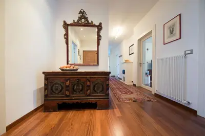 a room with a mirror and a wooden dresser at Josefshof in Caldaro