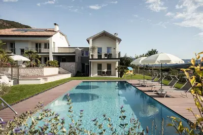 a villa with a swimming pool and a house at Josefshof in Caldaro