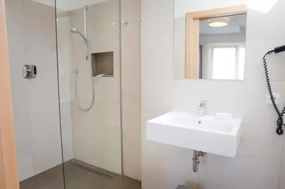 a bathroom with a sink and a shower at Haller Hof in Tirolo
