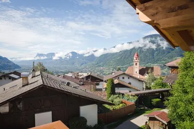a view of a village with mountains in the background at Haller Hof in Tirolo