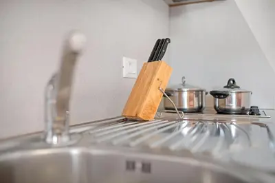 a knife block sitting on top of a kitchen sink at Appartements Beikircher in Valdaora