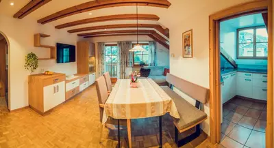 a kitchen and dining room with a table and chairs at Appartements Else in Ortisei