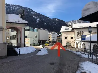 a street in a town with a snow covered mountain at Appartements Else in Ortisei
