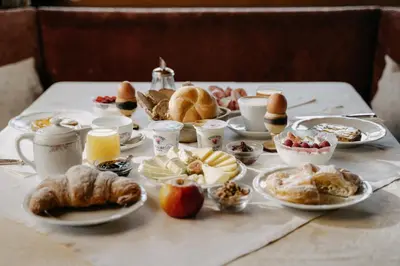 a table topped with plates of food and pastries at Boutique Hotel Pradell in Ortisei