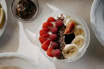 a dessert with fruit in a plastic bowl on a table at Boutique Hotel Pradell in Ortisei